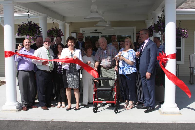 Officials celebrate the grand opening of the new All-American Assisted Living facility at 300 Rosebrook Way. BY MATTHEW BERNAT